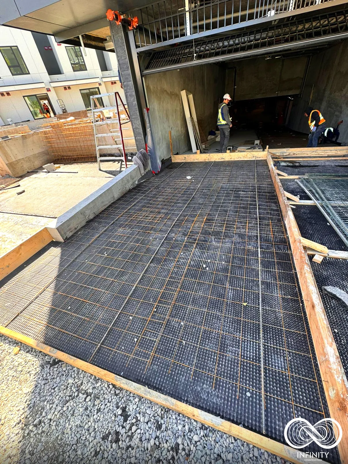 Rebar and reinforcement placed over a compacted base before a pour